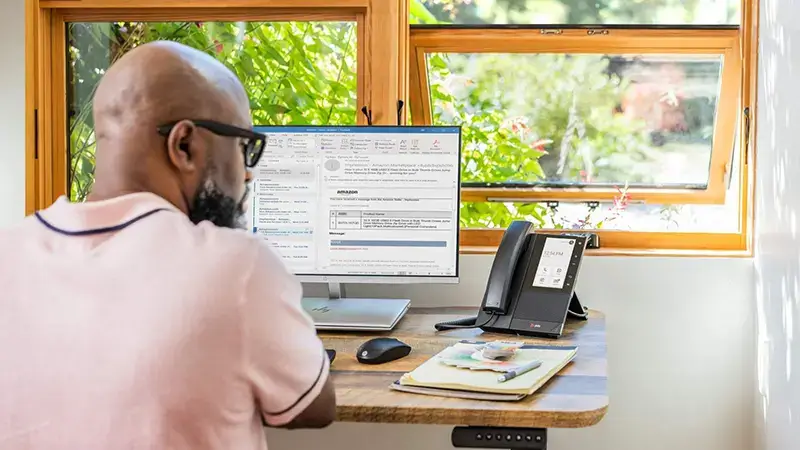 Male using Poly IP Phone for Microsoft Teams